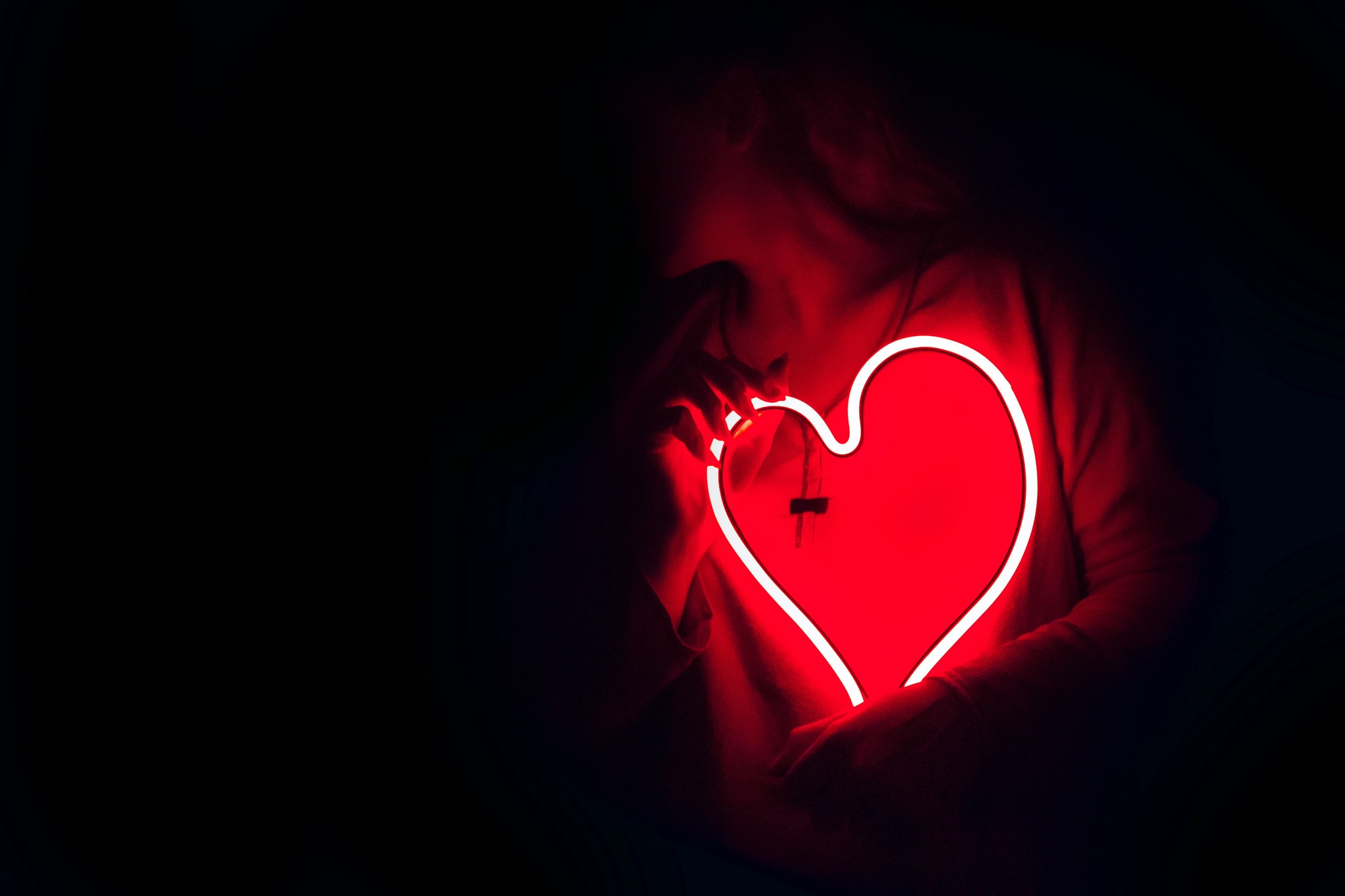 person holding glowing heart